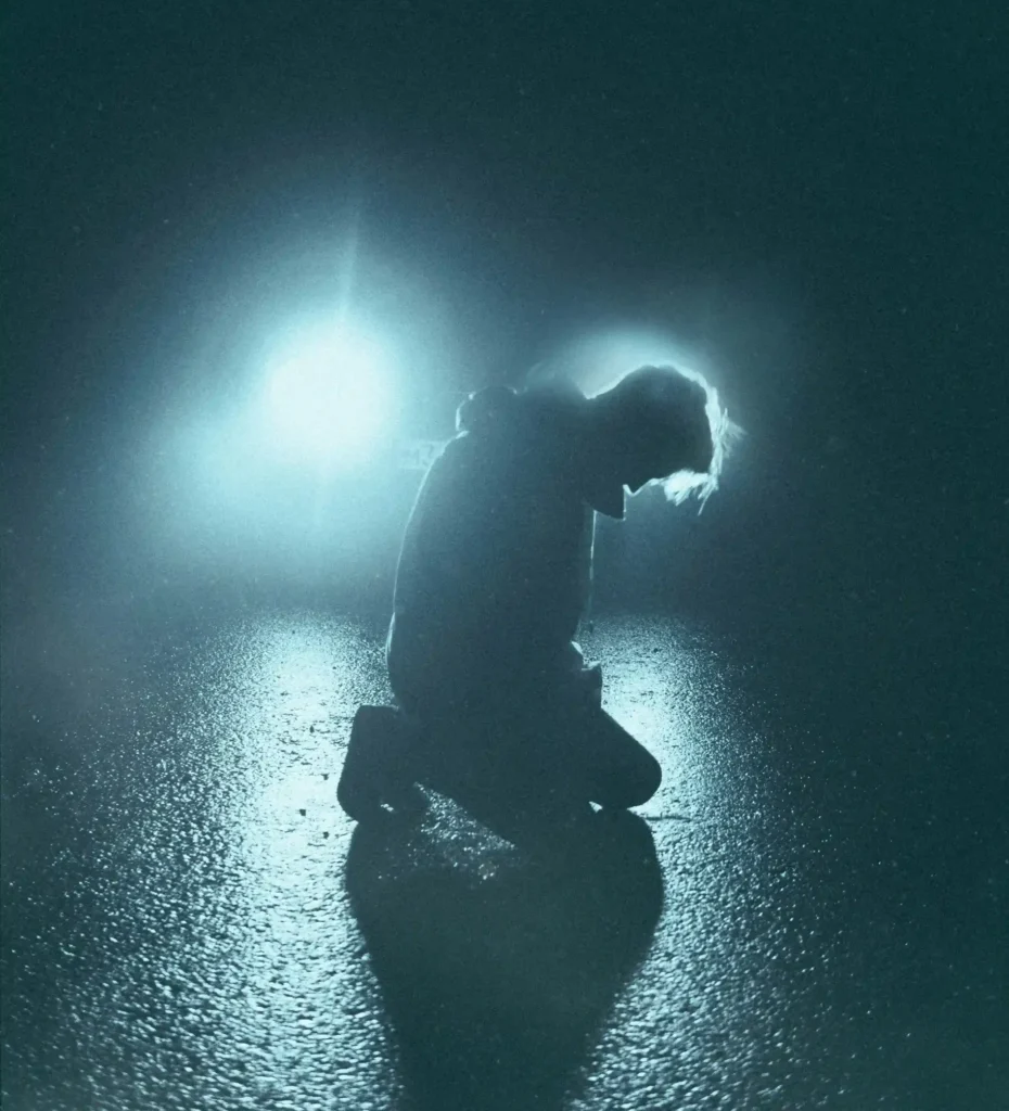 Person on their knees at night pondering “What Is My Purpose in Life”