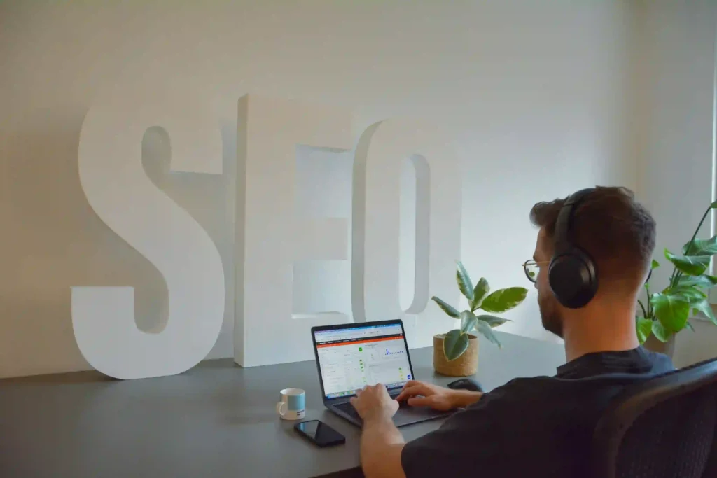 Small business owner analyzing SEO growth and Google search performance on a laptop dashboard